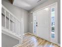 Bright foyer with hardwood floors, a staircase with white railing, and natural light at 7229 Georges Way, Morrow, GA 30260