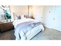 Cozy bedroom with a plush bed, stylish decor, soft carpet, and modern lighting fixtures at 113 Chestnut Trce # 8, Hapeville, GA 30354