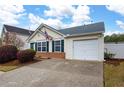 Inviting single-story home with an attached garage and neatly landscaped front yard with flowering bushes at 115 Oak Grove Pl, Acworth, GA 30102