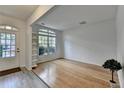 Inviting living room featuring large windows, hardwood floors, and neutral paint creating a bright, airy space at 3517 Harvest Ridge Ln, Buford, GA 30519