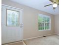 Entryway with decorative glass front door, large window, and neutral carpet at 67 Red Top Cir, Emerson, GA 30137