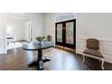 Elegant foyer features hardwood floors, decorative doors, and a table creating a welcoming ambiance at 2005 Westbourne Way, Alpharetta, GA 30022