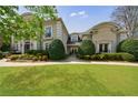 Beautiful home with manicured lawn, mature trees, and an inviting entrance at 2005 Westbourne Way, Alpharetta, GA 30022