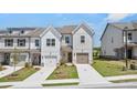 Modern townhome exteriors with crisp white facades, tidy landscaping, and private driveways at 257 Kenoot Dr # 42, Mcdonough, GA 30253