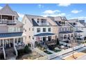 Attractive street view featuring inviting homes with well-kept lawns and charming front porches at 561 S Club Dr, Woodstock, GA 30188