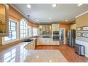 Well-lit kitchen featuring stainless steel appliances, granite countertops, and ample cabinet space at 1201 Lake Washington Dr, Lawrenceville, GA 30043