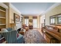 Elegant living room with fireplace, built-in bookshelves and a piano at 1201 Lake Washington Dr, Lawrenceville, GA 30043