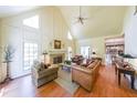 Elegant living room with high ceilings, fireplace, and hardwood floors at 1201 Lake Washington Dr, Lawrenceville, GA 30043