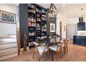 Elegant dining area showcases a large bookshelf, hardwood floors, and stylish decor near the kitchen at 220 3Rd St, Fayetteville, GA 30214