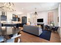 Open-concept living room boasts a modern fireplace, wood floors, and a seamless connection to the kitchen at 220 3Rd St, Fayetteville, GA 30214