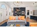 Spacious living room featuring a custom bookshelf, hardwood floors, and an elegant chandelier at 220 3Rd St, Fayetteville, GA 30214