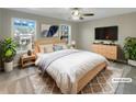 Staged bedroom with a plush rug, ceiling fan, and large windows providing plenty of natural light at 2555 Flat Shoals Rd # 3405, Atlanta, GA 30349