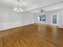 Bright open living area with hardwood floors, ceiling fan, and access to the outdoor space at 2555 Flat Shoals Rd # 3405, Atlanta, GA 30349