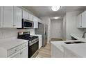 Bright kitchen features modern stainless steel appliances, including a gas range and ample counter space at 3035 Sherbourne Dr, Lithonia, GA 30058