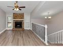 Spacious living room with hardwood floors, a stone fireplace, and large windows at 2780 Creekwood Ln, Lawrenceville, GA 30044