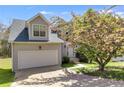 Inviting two-story home with an attached garage and lush front yard, offering both curb appeal and convenience at 4542 White Rd, Douglasville, GA 30135