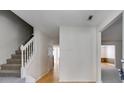 Bright hallway with hardwood floors and stairs, creating a welcoming entrance to the home at 4542 White Rd, Douglasville, GA 30135