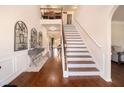 Grand foyer with hardwood floors, staircase and elegant decor, leading to various living spaces at 817 Nevis Way, Mcdonough, GA 30253