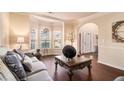 Cozy living room with large windows, decorative pillows, and an ornate coffee table for gatherings at 817 Nevis Way, Mcdonough, GA 30253