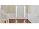 Light-filled entryway with hardwood floors and a bright white front door at 2983 Bancroft Nw Gln, Kennesaw, GA 30144