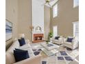Bright living room featuring a fireplace, soaring ceilings, and modern furniture at 2983 Bancroft Nw Gln, Kennesaw, GA 30144