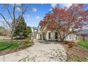 Attractive home showcasing a curved driveway, mature landscaping, and charming architectural details at 5489 White Cedar Ter, Sugar Hill, GA 30518