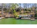Expansive lake view with a covered dock featuring ample seating, perfect for relaxing at 778 Lakeview Ln, Berkeley Lake, GA 30096