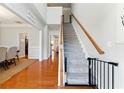 Inviting foyer featuring hardwood floors, a staircase with wooden railings and grey carpet at 813 Topaz Vly, Canton, GA 30114