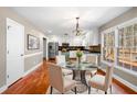 Bright breakfast nook features stainless steel appliances, white cabinets, and modern chandelier at 100 Oakwind Pkwy, Canton, GA 30114