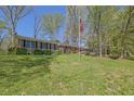 Beautiful brick home with a manicured lawn, mature trees, and American flag displayed at 3969 Potomac Nw Dr, Kennesaw, GA 30144