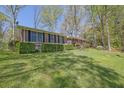 Well-maintained brick home with manicured hedges, a spacious front yard, and mature trees at 3969 Potomac Nw Dr, Kennesaw, GA 30144