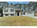 Charming two-story home featuring a well-manicured lawn and a two-car garage at 5155 Rosestone Nw Dr, Lilburn, GA 30047