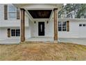 Inviting front porch with wood columns and a modern front door at 5155 Rosestone Nw Dr, Lilburn, GA 30047