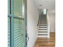 Bright entryway showcasing hardwood floors, staircase with modern railings, and plenty of natural light at 4460 Dalston Ne Dr, Atlanta, GA 30342