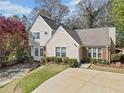 Charming two-story home featuring a well-manicured lawn and tasteful landscaping and driveway at 5032 Laurel Springs Se Way, Smyrna, GA 30082