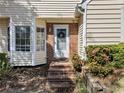Inviting front entrance featuring a brick pathway, well-kept shrubs, and a classic white door with a wreath at 5032 Laurel Springs Se Way, Smyrna, GA 30082
