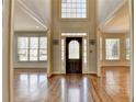 Welcoming foyer with hardwood floors, lots of light, and decorative front door at 5190 Deerlake Dr, Alpharetta, GA 30005