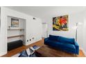 Cozy living room with a blue sofa, modern art, and open shelving at 1355 Euclid Ne Ave # 21B, Atlanta, GA 30307