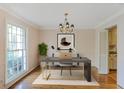 Traditional dining room virtually staged as an office with hardwood floors and natural light at 3474 Castleridge Dr, Tucker, GA 30084
