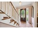 Inviting foyer with brick flooring, a decorative front door, staircase and chandelier at 3474 Castleridge Dr, Tucker, GA 30084