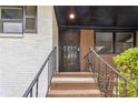 Close up view of a metal security door leading to the entrance, with stairs and metal railings at 2267 Bryant Dr, East Point, GA 30344