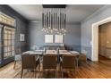 Sophisticated dining room featuring modern lighting, gray walls, and beautiful hardwood floors at 3720 River Mansion Dr, Peachtree Corners, GA 30096