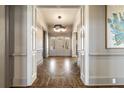 Grand foyer with herringbone wood floors, decorative molding, and an elegant chandelier at 3720 River Mansion Dr, Peachtree Corners, GA 30096