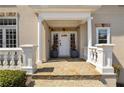 Charming covered front porch with stone tile, stately columns, and a welcoming entrance at 3720 River Mansion Dr, Peachtree Corners, GA 30096