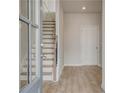 Inviting foyer showcasing hardwood flooring, a staircase with wooden banister, and natural light at 608 Marimba Pike, Mcdonough, GA 30253
