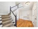 A delightful foyer featuring gleaming wood floors, a winding staircase, and ornate trim in a bright and airy space at 1260 Centenary Rdg, Snellville, GA 30078