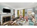 Comfortable living room with a fireplace, built-in shelves, and a door leading to the outside at 2260 Peachtree Nw Rd # D6, Atlanta, GA 30309