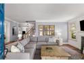 Inviting living room with hardwood floors, a gray sectional sofa, and stylish decor at 26 Standish Nw Ave, Atlanta, GA 30309