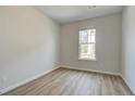 Cozy bedroom with hardwood floors, a window, and neutral paint at 612 Marimba Pike, Mcdonough, GA 30253