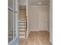 Inviting entryway with hardwood floors, stairs to upper level, and neutral paint at 612 Marimba Pike, Mcdonough, GA 30253